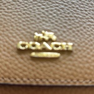 New Coach Tan Pebbled Leather Wallet with Gold Logo Accent.